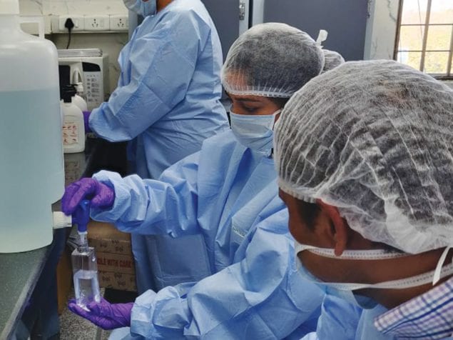 AIIMS staff preparing alcohol-based rub to address increased demand during the COVID-19 surge, 2020