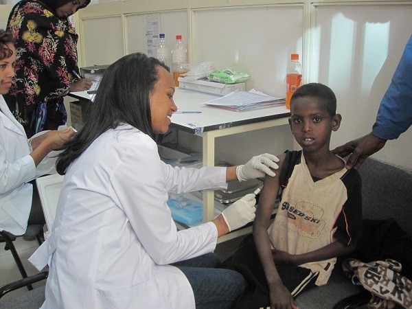 Abdi Yusuf, 12, is vaccinated at the IOM clinic in Kakuma refugee camp during the medical health assessment process for US-bound refugees.