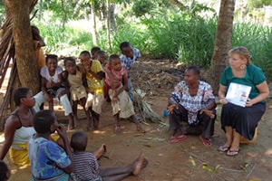 Peace Corps volunteer Kelly Sawyer speaks with mothers about preventing malaria in pregnancy.