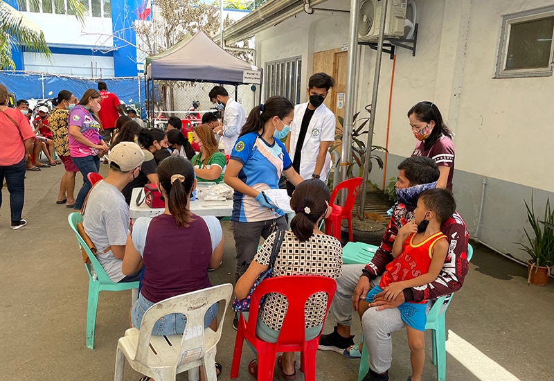 Health workers engage with community members seeking care at a CDC-supported social hygiene clinic in Cebu, Philippines.