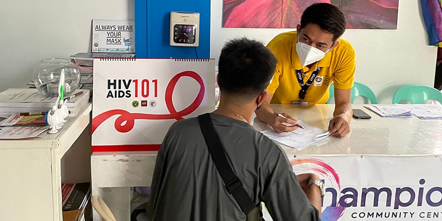 A health worker engages with a patient at a CDC-supported HIV testing and treatment center in Iloilo City, Philippines.
