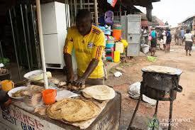 A food vender makes chapatis. 