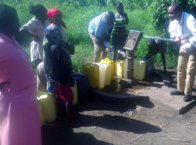 Fellows collecting water samples for testing. 