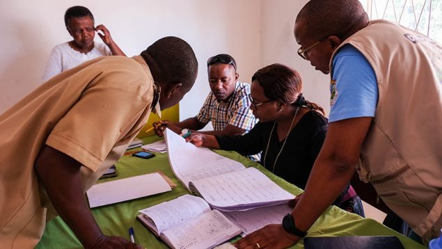 CDC, ZimTTECH and MOHCC cadres review HIV program registers at Mdutshane Clinic in Bubi District.