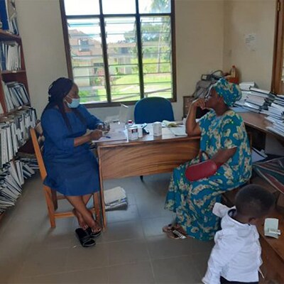 Redempta Mushi, Amref-supported-Pediatric officer, Afya Kamilifu attending to a client in a de-congested environment.