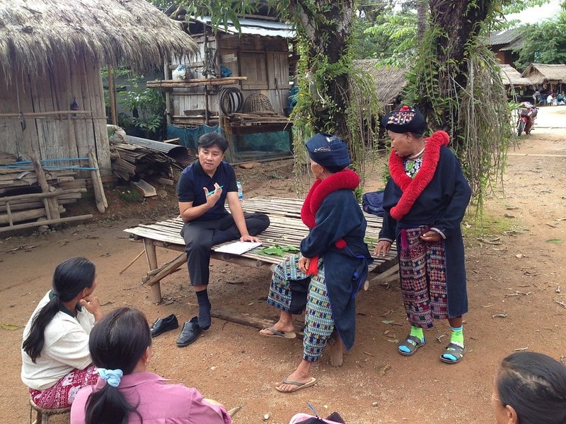 A health professional engages with community members in rural Thailand