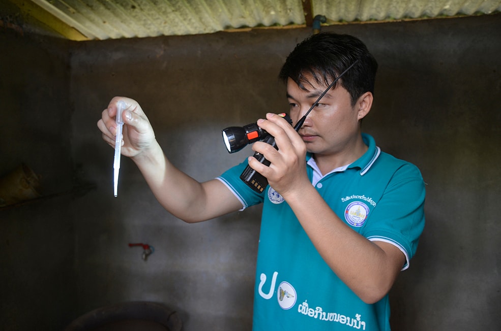 Lao FETP trainee examining equipment during an investigation. Photo: Billy Weeks