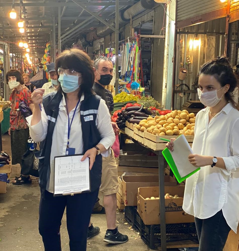 Lia Sanodze and team conduct a COVID-19 survey at a marketplace.