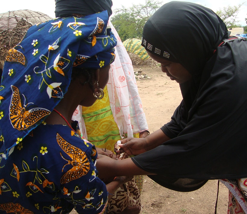 Dr. Endie Waziri vaccinating a nomadic Fulani child in Gwaskaram, Bauchi State, Nigeria. Photo: NSTOP Team