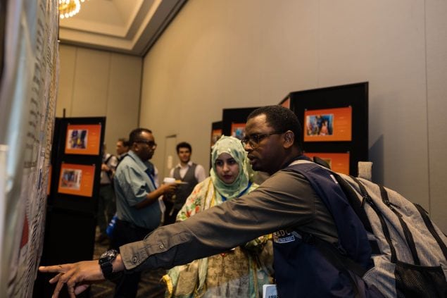 Participants discuss a scientific poster during the 2023 FETP International Nights poster session