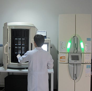 Scientist using the new laboratory system. It is a state-of-the-art, automated instrument which is faster than conventional, manual methods.