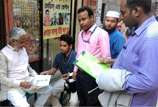 FETP fellows Dr. Omar Qayum (second from left) and Dr. Sirajul Islam (third from left) sharing chikungunya information with a community member in Dhaka, Bangladesh on June 17, 2017.