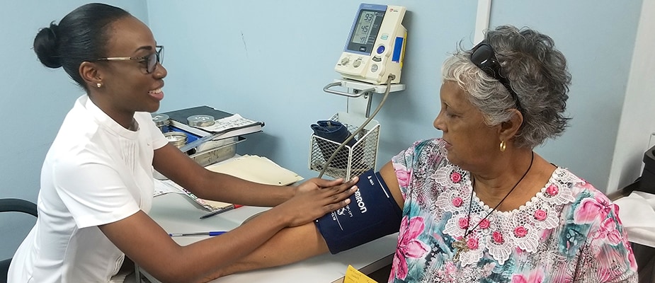 A nurse checks the blood pressure of a woman at a clinic in Sangre Grande, Trinidad. Photo: PAHO