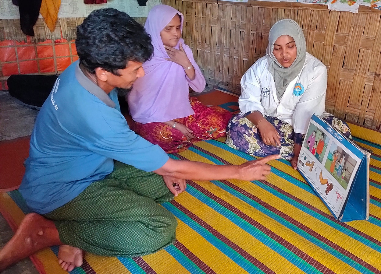  In 2019, before the COVID-19 pandemic, expectant parents receiving prenatal care counseling at home in Cox's Bazar, Bangladesh, where community-delivered services save lives.  Photo: Endang Handzel  