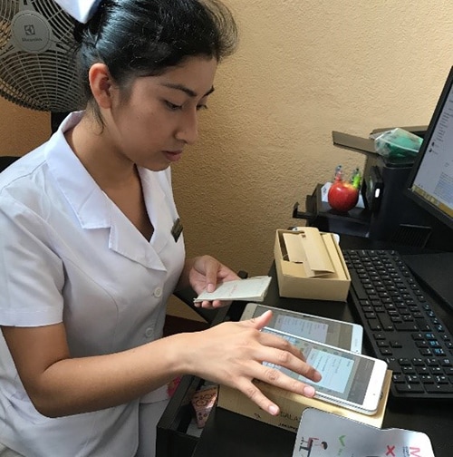 GUATEMALA: Nurse Karen Orozco loading new tablets for capturing data on febrile illness patients as part of a community surveillance study. Photo: Joe P. Bryan