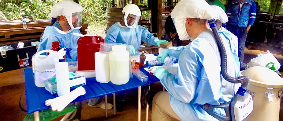 Clint Morgan and Jeffrey Doty of CDC guide the One Health team in laboratory techniques at Afi Mountain. Photo: Muhammed Saleh