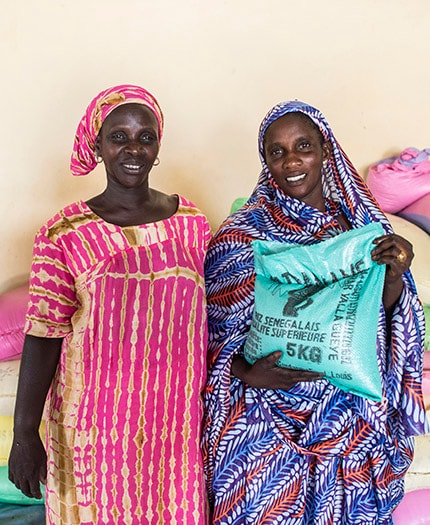 Tabaski Gaye (l) and Arame Gaye are members of the Khar Yalla Gueye, a women's group operating a small-scale grain milling operation in Senegal. Photo: Scott McPherson, RTI International