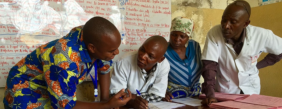 While reviewing maternal and newborn health records with a midwife (center) in Goma, DRC, she had to leave twice to deliver babies. Photo:: Alaine Knipes, CDC