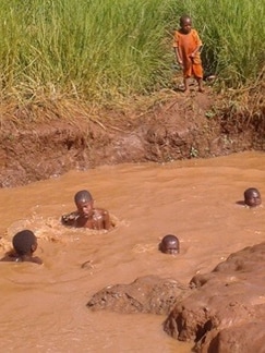 Children taking a bath at Kajana village