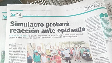 A news headline in Colombia announces the simulation exercise.