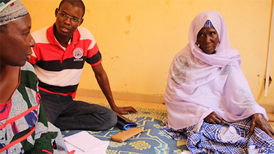 FETP investigator Kouawo Laurent Mariame (left) conducts an interview during a maternal child health study.