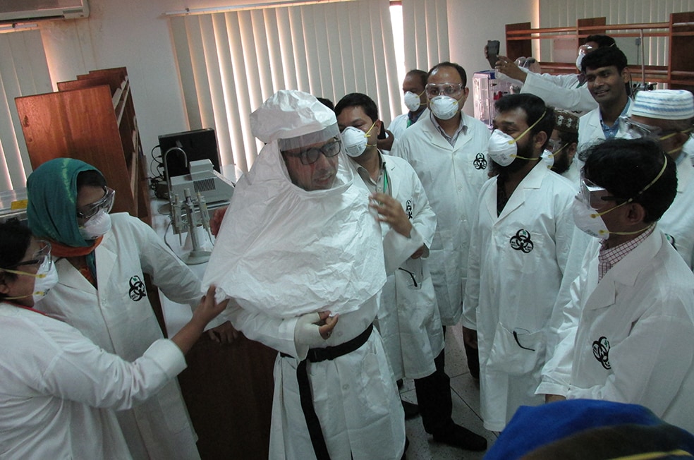 High level containment PPE donning and doffing exercise during laboratory biosafety and biosecurity training in Dhaka, Bangladesh (2016).