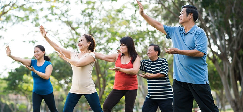 Older Asian adults practice Tai Chi.