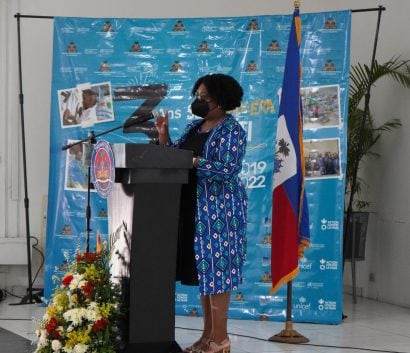 speaker at a podium during third anniversary of final cholera case in Haiti