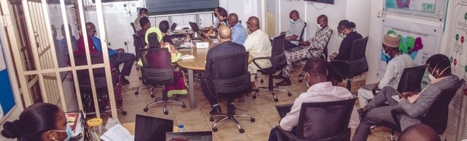 Nigeria CDC leadership and staff in the EOC for the daily review of COVID-19 data and response duties.