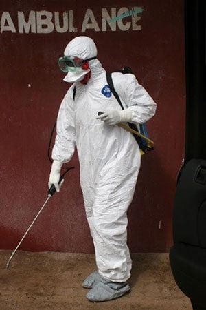 A health care worker decontaminates the ambulance area outside of Redemption Hospital in Monrovia, Liberia.