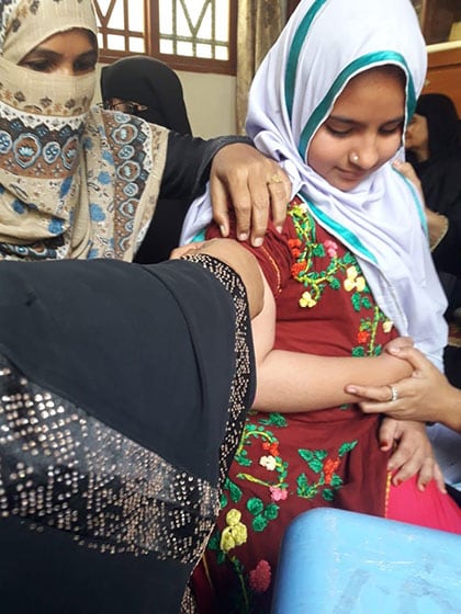 An adolescent girl receives a typhoid vaccine in Pakistan, 2019.