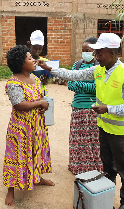 Woman receives an oral cholera vaccine in DRC.