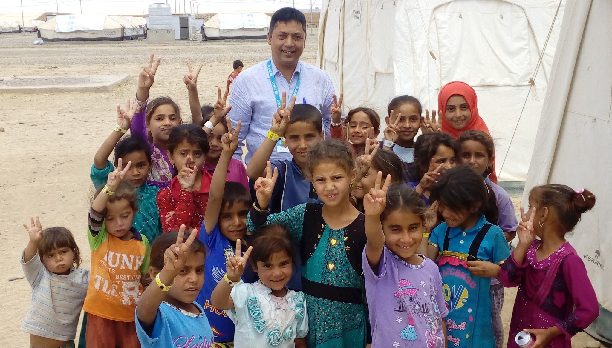 Smiling children and STOP participant in Syria after successful vaccination campaign 