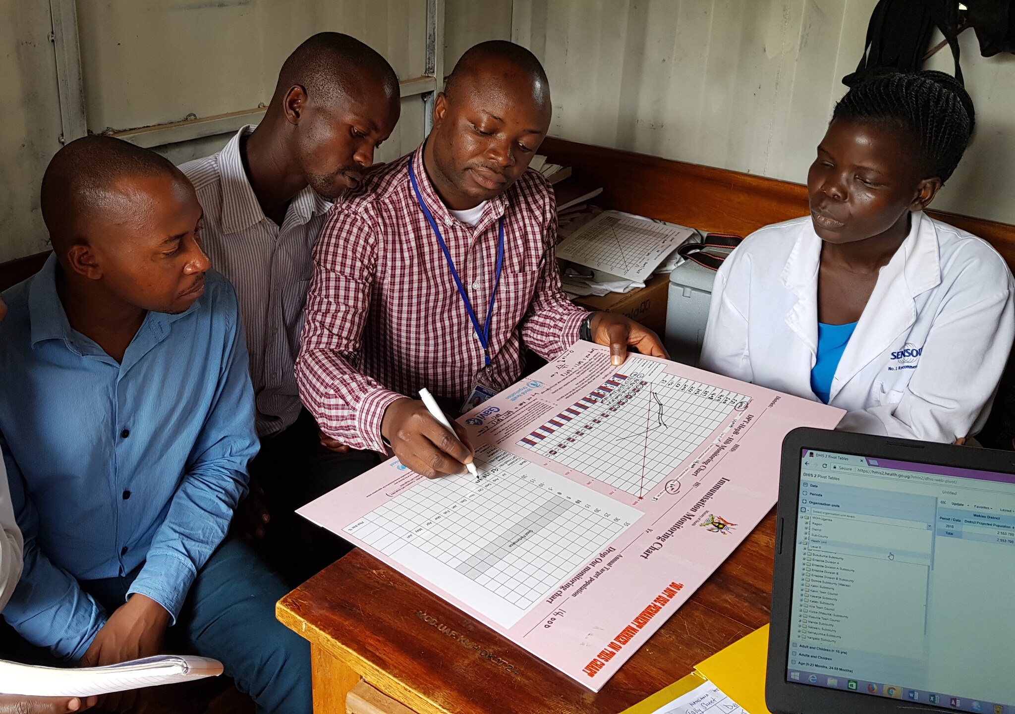 STOP participant training health workers in Uganda on completing vaccine monitoring charts