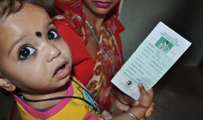 A child holding his vaccination card at a health facility in Rajasthan, India. Courtesy of Steve Stewart/CDC.