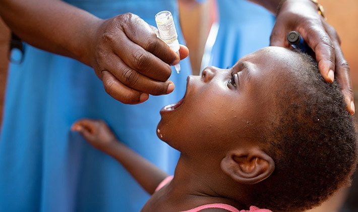 A child receives oral polio vaccine.