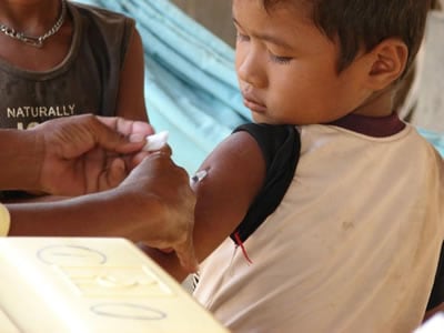 A young Cambodian child receives a measles vaccination