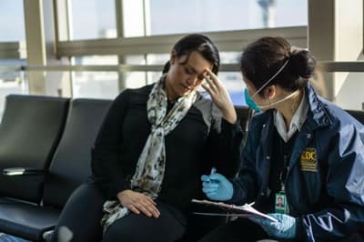 CDC Quarantine Station Public Health Officer Diana Wu assesses a sick traveler who arrived to the U.S. from another country.