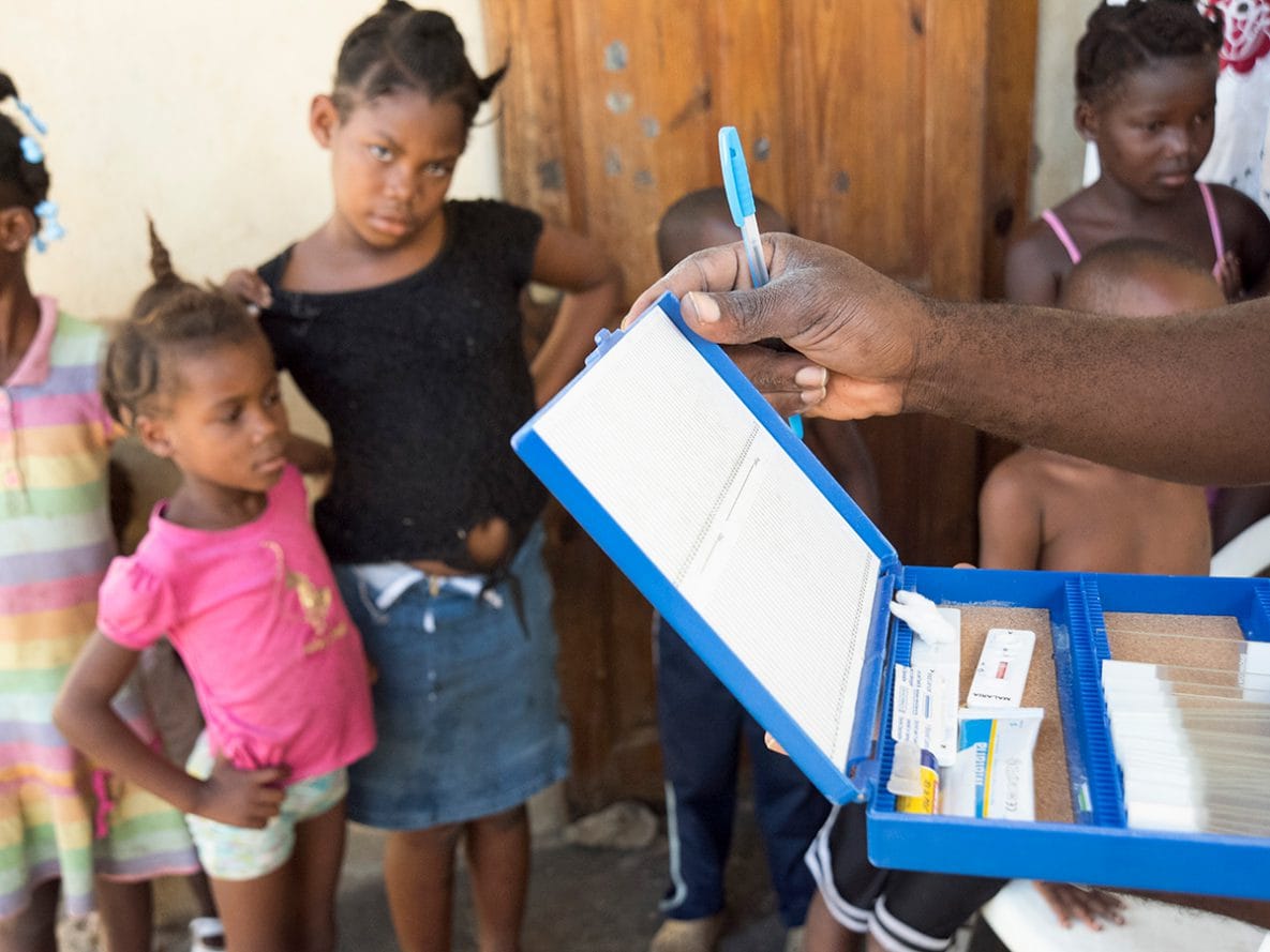 A community health worker in Haiti prepares to conduct Rapid Diagnostic Tests integrated with screening for lymphatic fillariasis.