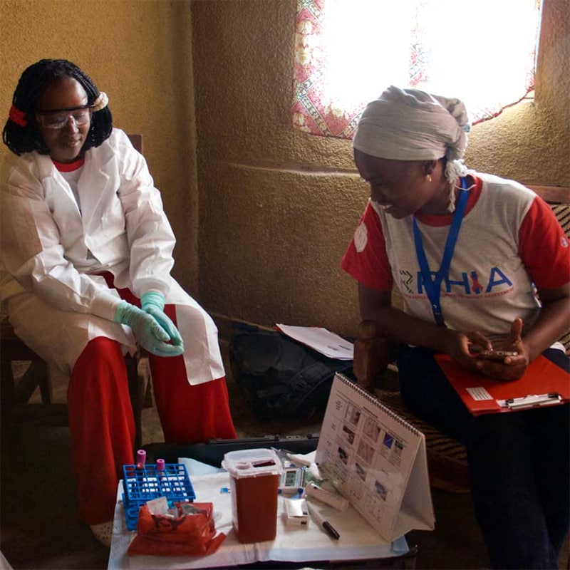 Community workers in a local citizen’s home after collecting blood samples