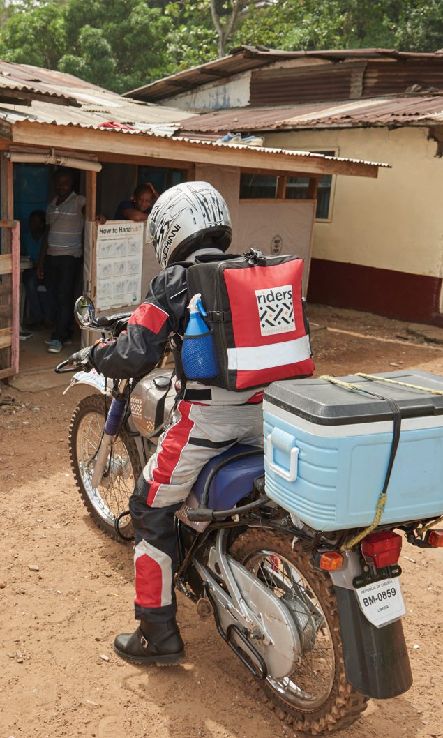 A &ldquo;Riders for Health&rdquo; motorcycle courier delivers laboratory samples over rough roads in Liberia. Photo Courtesy: Nicole Hawk