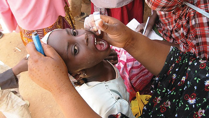 A child receives polio drops during a vaccination campaign in Katsina State, Nigeria, 2014.   Credit: CDC STOP Program, A.J. Williams