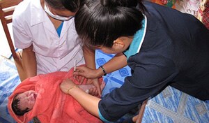 The First dose of hepatitis B vaccine, given within 24 hours of birth, is administered to a baby in Laos.