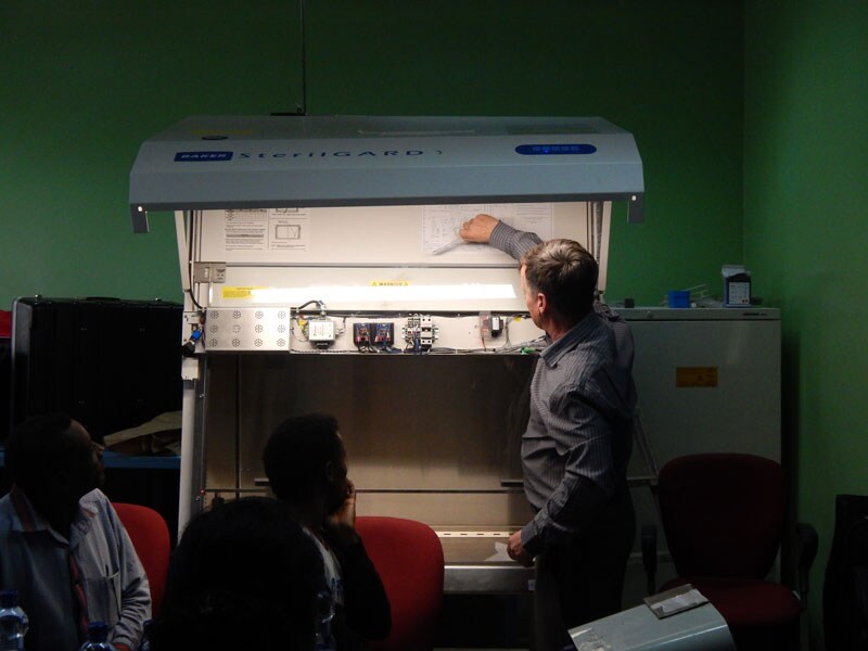 An Eagleson Institute trainer shows how to test in-flow and down-flow on the biosafety cabinets.