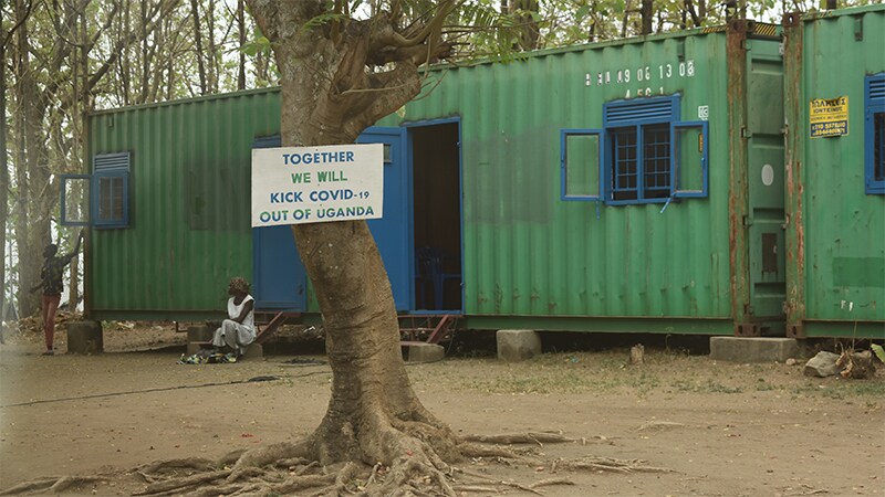 Sign mounted on tree outside local ABHR production facility in Amuru