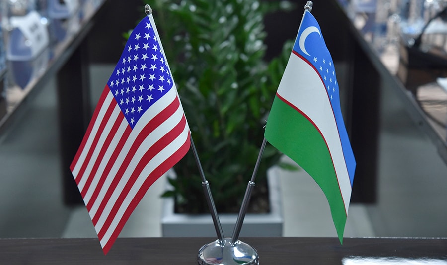 Flags of the United States of America and the Republic of Uzbekistan adorned a meeting table