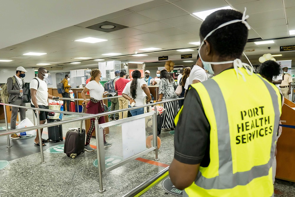 Photo of a Port Health Services official monitoring the screening of in-bound passengers at the Murtala Muhammed International Airport, Lagos.