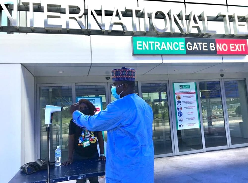 Photo of Dr. Muhammad Saleh, a CDC emergency response staff member, taking temperatures of people at Harcourt International Airport in Nigeria.