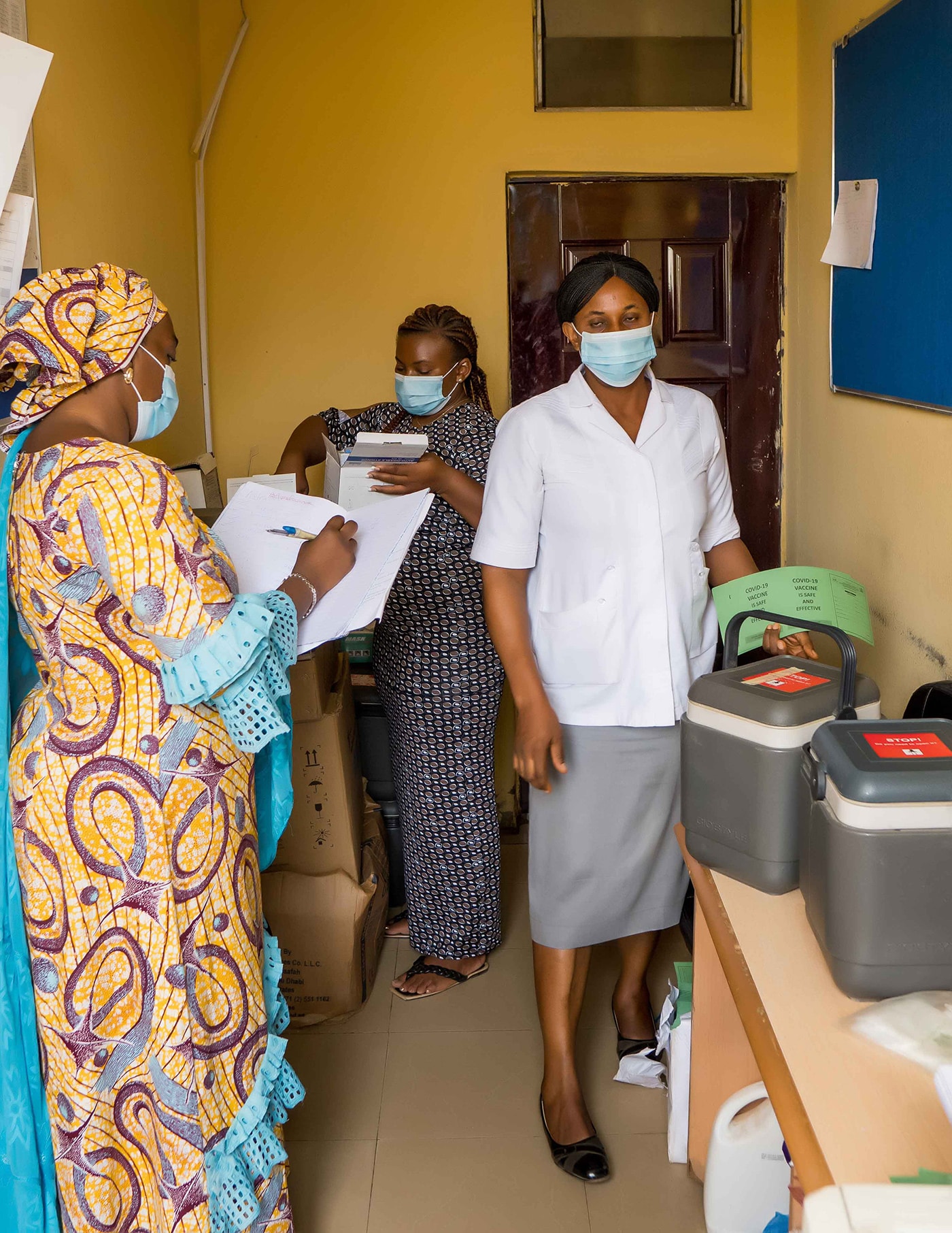 Photo of healthcare workers preparing vaccines for distribution to local vaccination sites in Abuja.