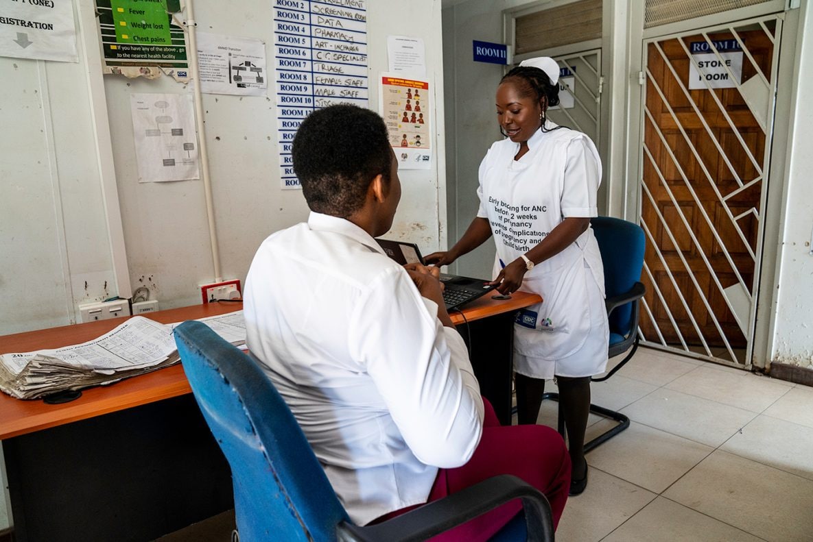 Photo of a heath care worker talking with a patient at a PEPFAR-supported clinic.